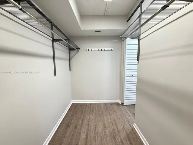 a view of a room with wooden floors and led lights