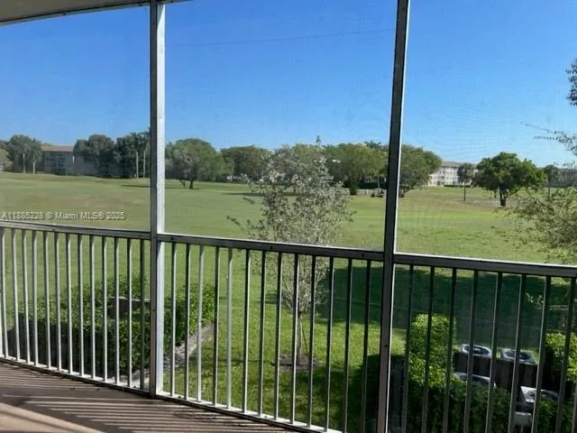 a view of a balcony next to a yard