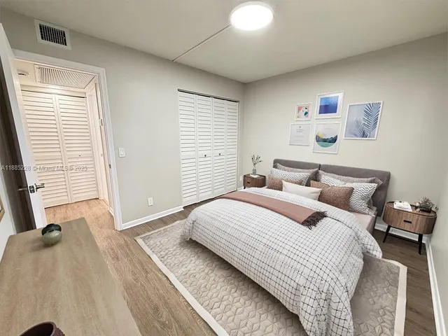 a bedroom with a bed and a large window