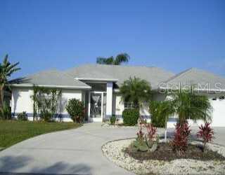 a view of a house with palm trees