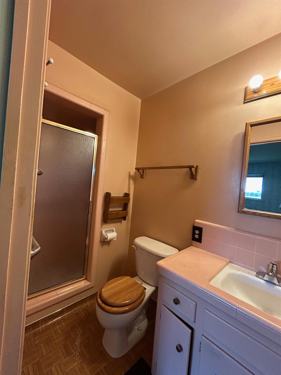 117 Berry Drive Madera, CA 93637 - Photo 13 of 16 a bathroom with a granite countertop toilet sink and shower