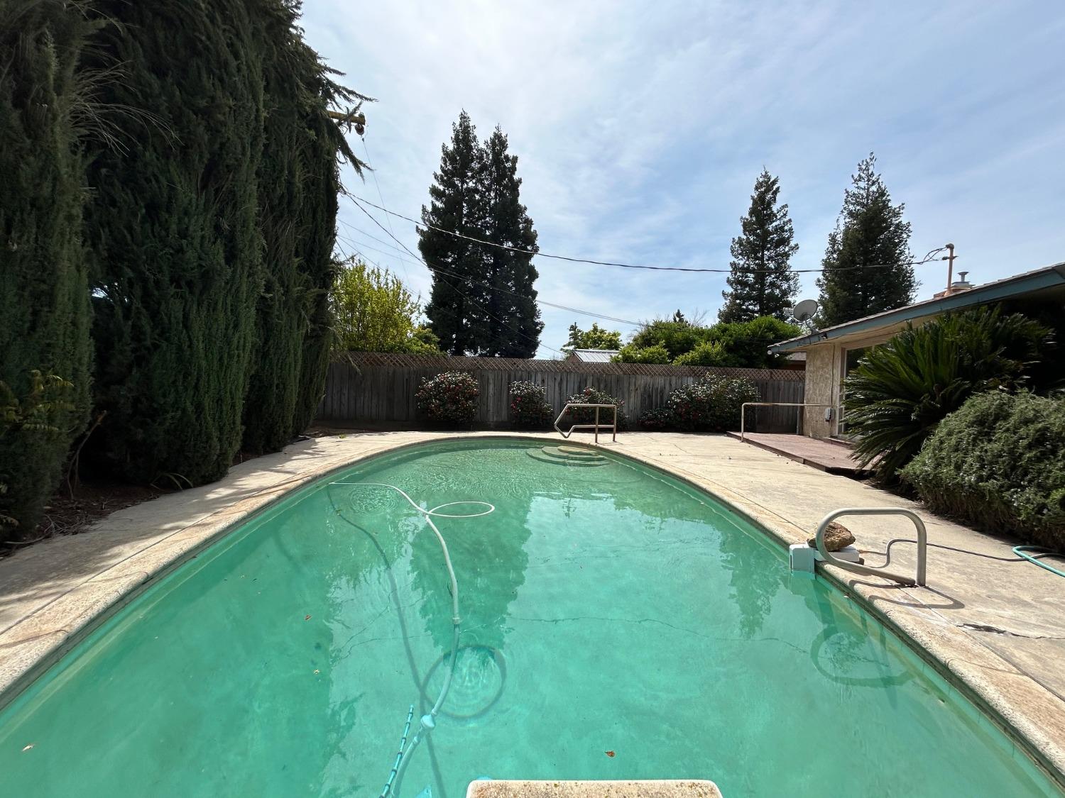 117 Berry Drive Madera, CA 93637 - Photo 15 of 16 a swimming pool with a yard