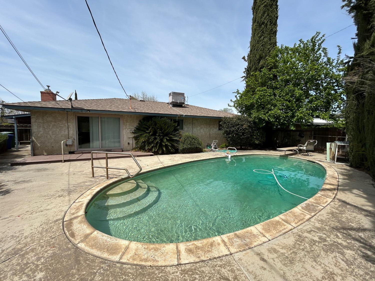 117 Berry Drive Madera, CA 93637 - Photo 16 of 16 a view of a swimming pool with a yard