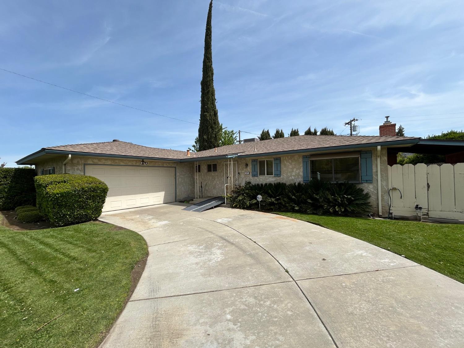 117 Berry Drive Madera, CA 93637 - Photo 2 of 16 a front view of a house with a yard and trees