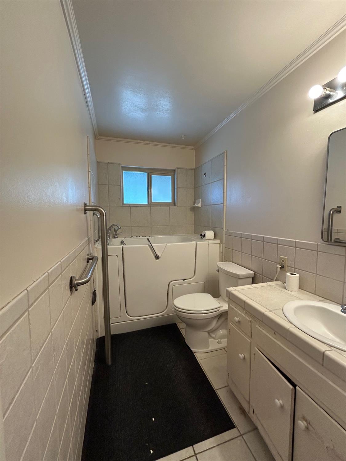 117 Berry Drive Madera, CA 93637 - Photo 8 of 16 a spacious bathroom with a toilet a sink and mirror