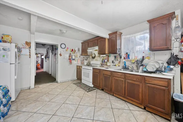 a kitchen with a sink cabinets and refrigerator