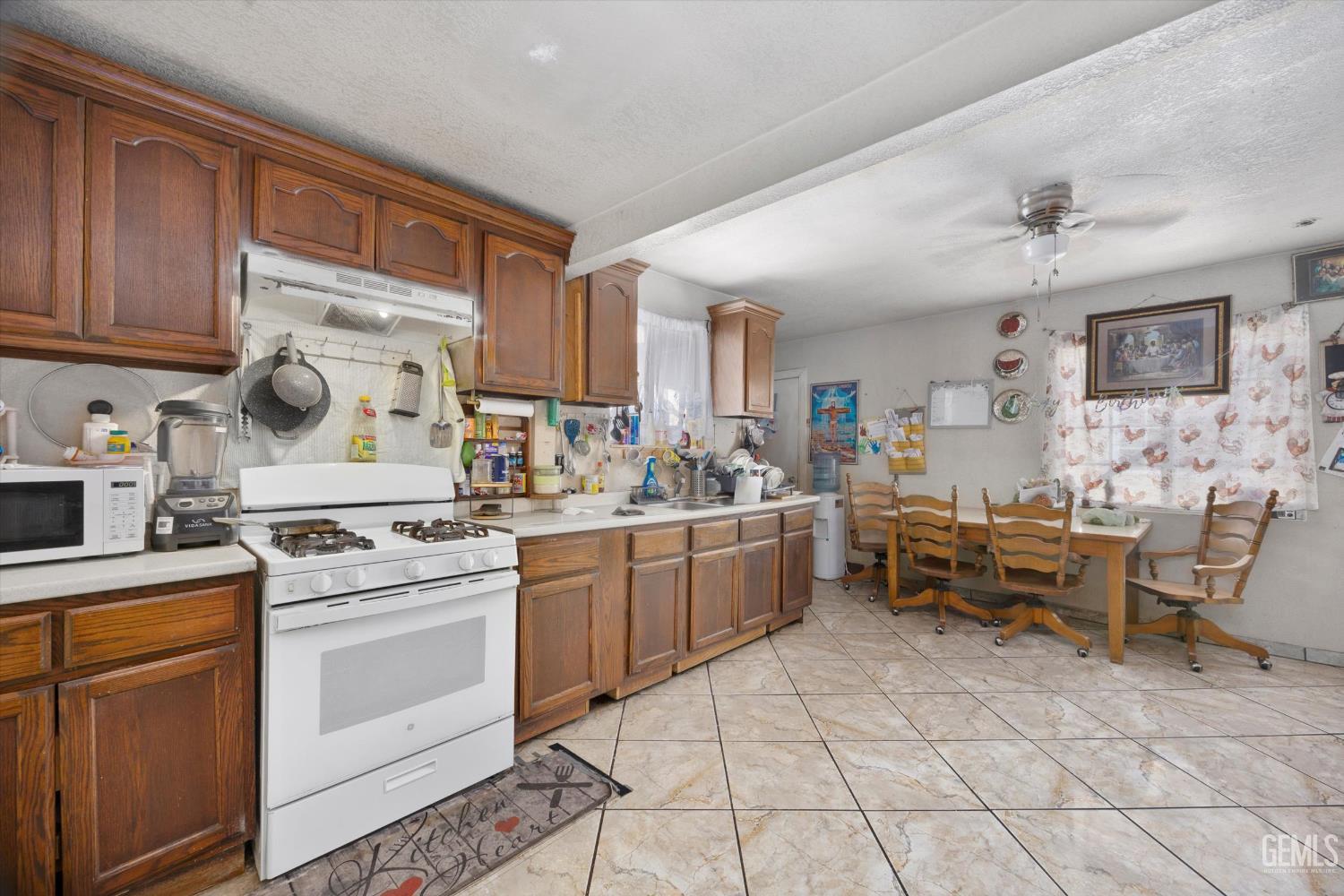 Undisclosed Address Delano, CA 93215 - Photo 23 of 43 a kitchen with cabinets and chairs