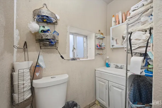a bathroom with a sink toilet and mirror
