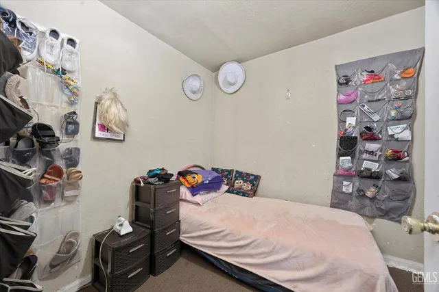 a bedroom with a bed and cabinets