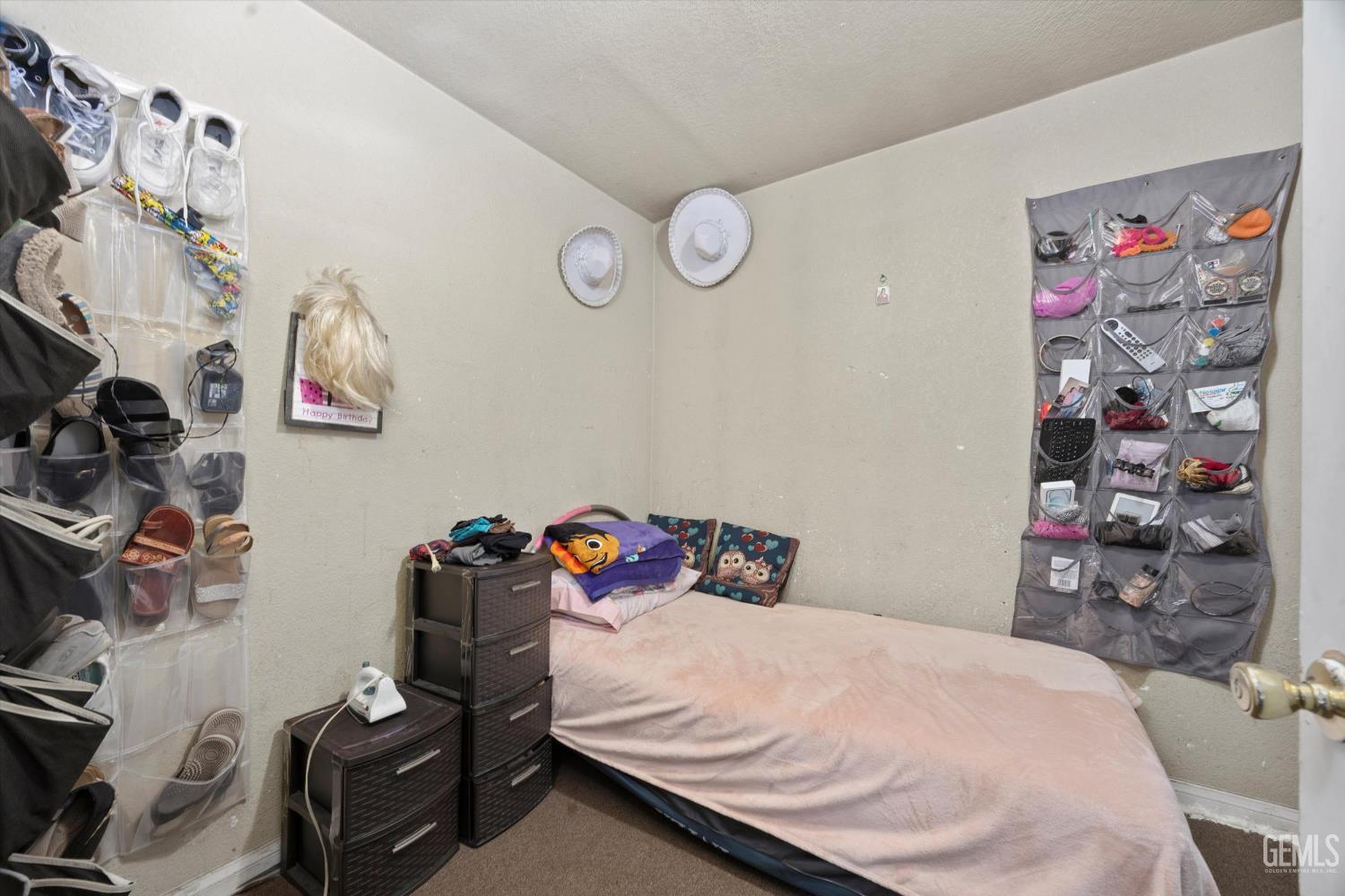 Undisclosed Address Delano, CA 93215 - Photo 27 of 43 a bedroom with a bed and cabinets