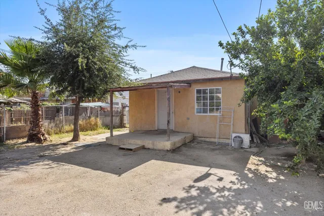 a backyard of a house with a tree