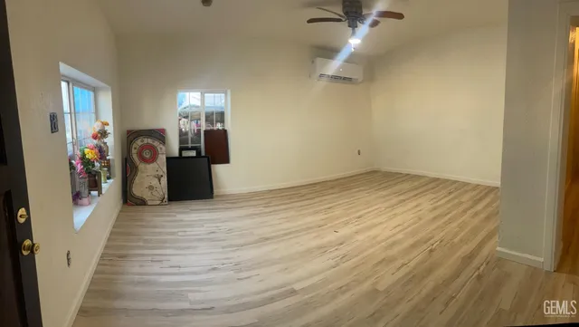 a view of a room with wooden floor