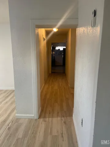 a view of a room with wooden floor