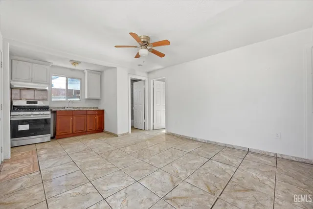 a open kitchen with cabinets and stainless steel appliances