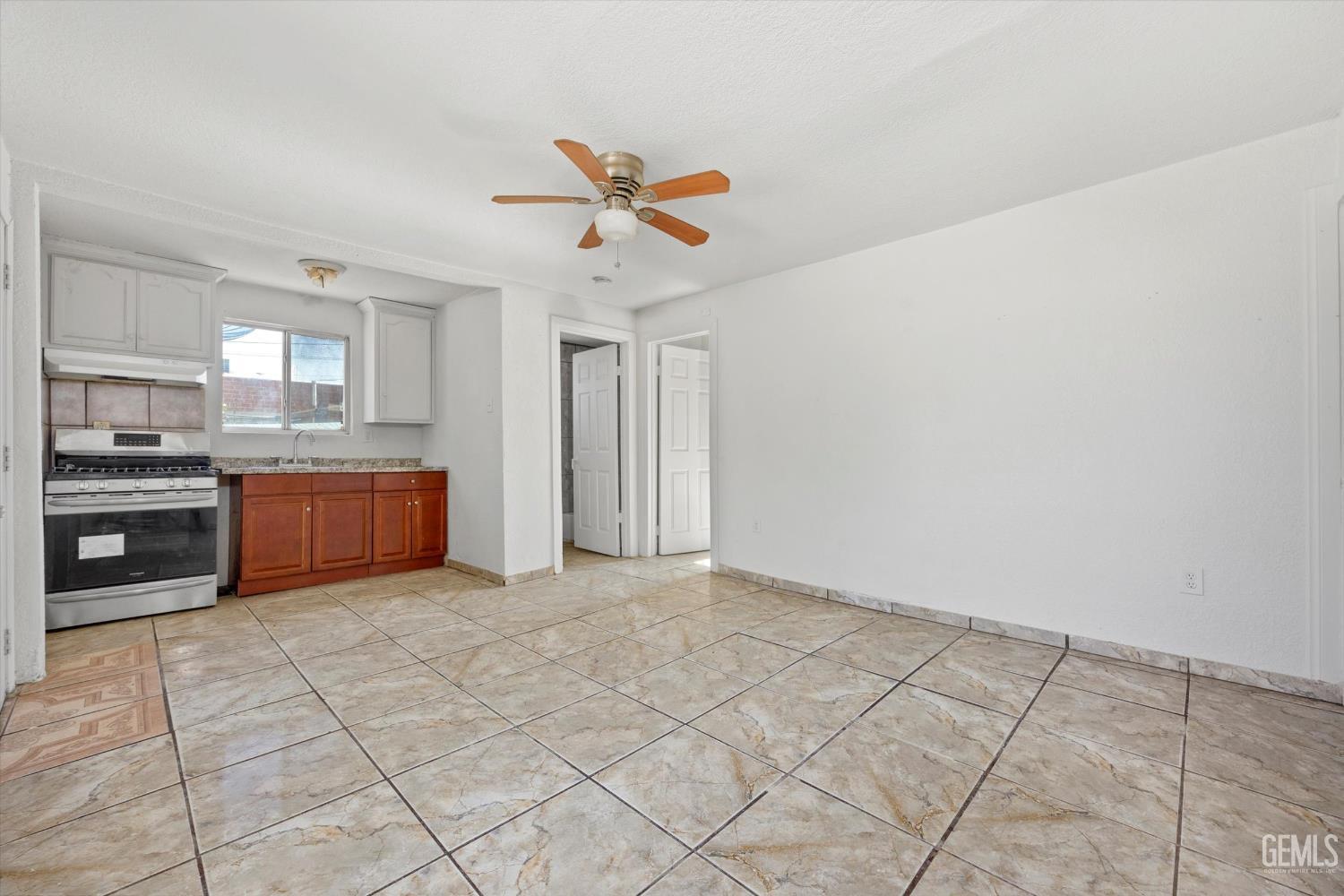Undisclosed Address Delano, CA 93215 - Photo 5 of 43 a open kitchen with cabinets and stainless steel appliances