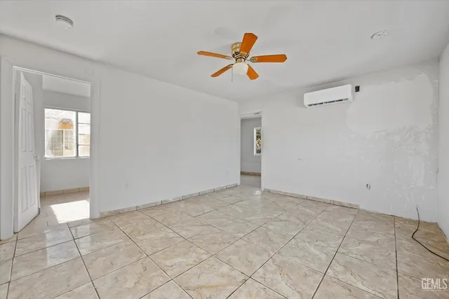 a view of a livingroom with a ceiling fan and window