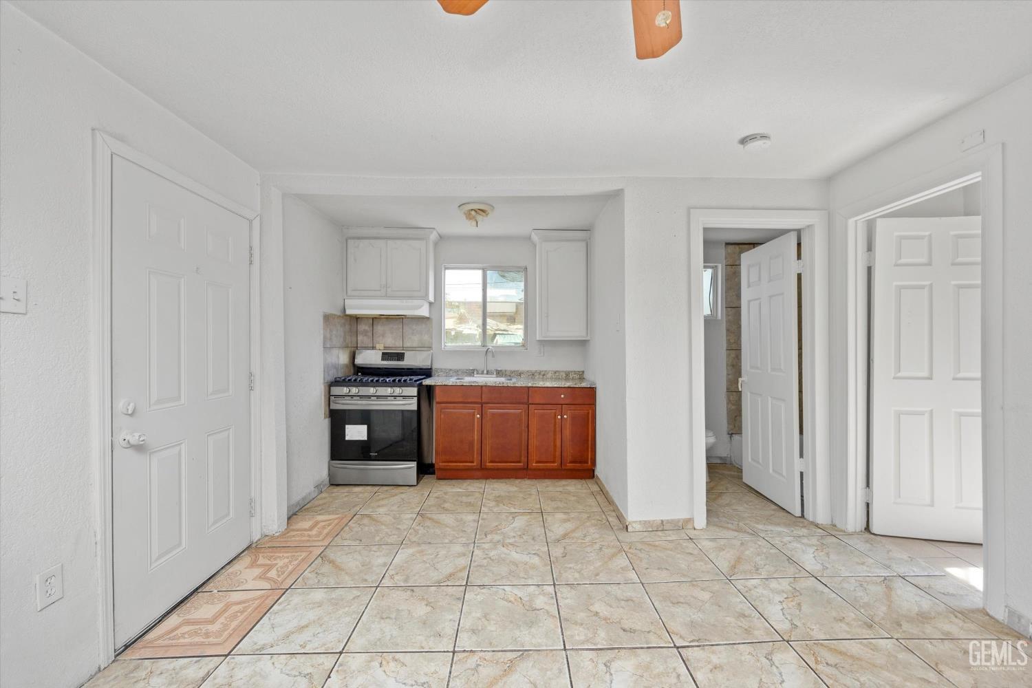 Undisclosed Address Delano, CA 93215 - Photo 7 of 43 a kitchen with stainless steel appliances granite countertop a refrigerator and a sink