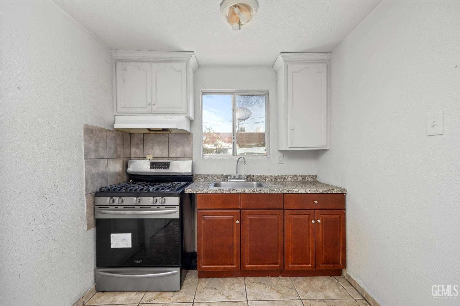 Undisclosed Address Delano, CA 93215 - Photo 8 of 43 a kitchen with stainless steel appliances granite countertop a stove and a sink