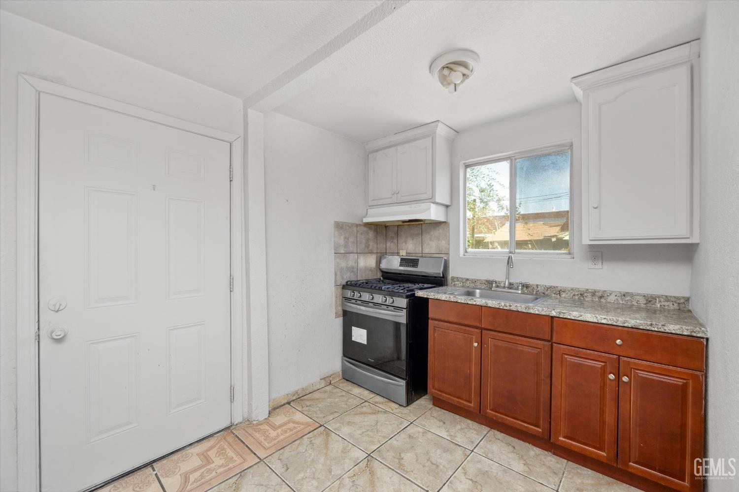 Undisclosed Address Delano, CA 93215 - Photo 9 of 43 a kitchen with stainless steel appliances granite countertop a stove a sink and a refrigerator
