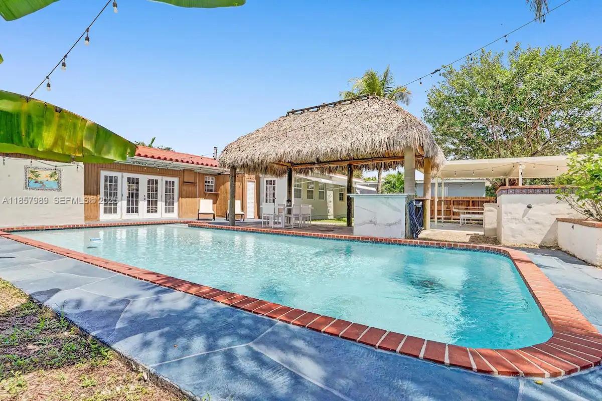 swimming pool view with a outdoor seating