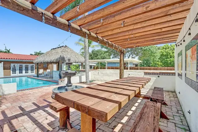 a view of house with backyard and outdoor seating