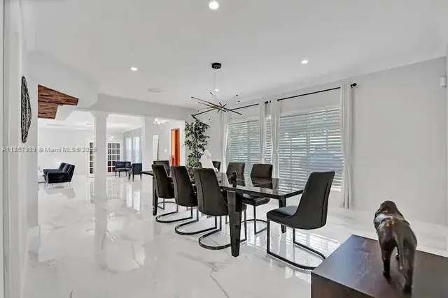 a view of a dining room with furniture and chandelier