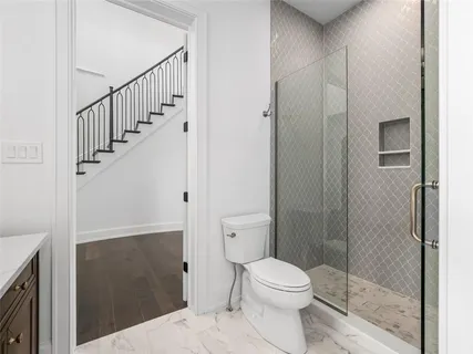 a bathroom with a toilet and a shower