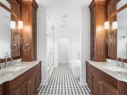 a bathroom with a double vanity sink and a mirror