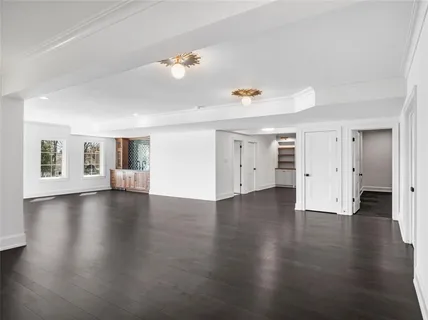 a view of a livingroom with wooden floor and windows