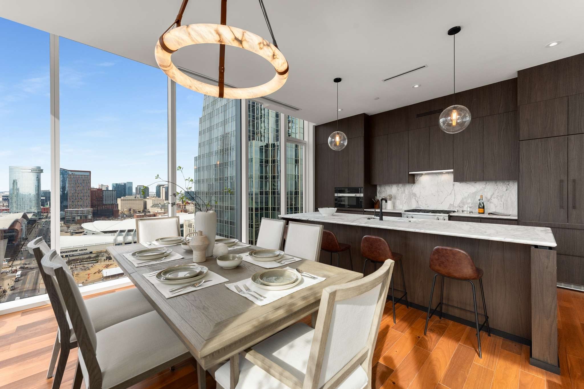 160 2nd Avenue South, Unit 1902 Nashville, TN 37201 - Photo 1 of 40 a dining room with stainless steel appliances kitchen island granite countertop a table chairs and a refrigerator