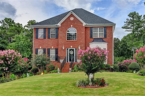 a front view of a house with a yard