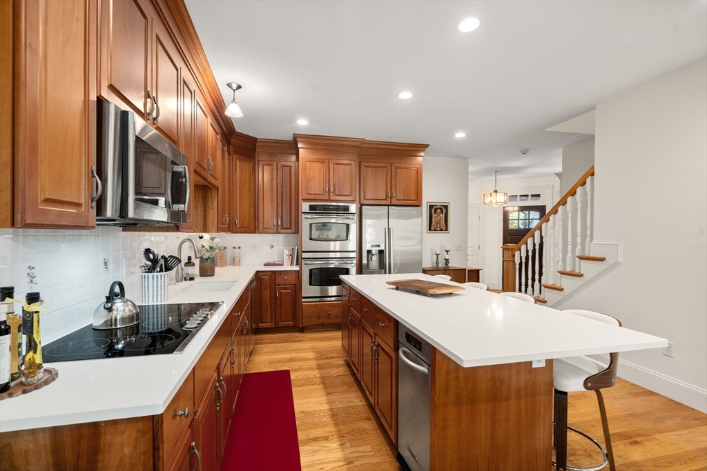 287 Langley Road, Unit 43 Newton, MA 02459 - Photo 9 of 36 a kitchen with a stove a sink a refrigerator and cabinets