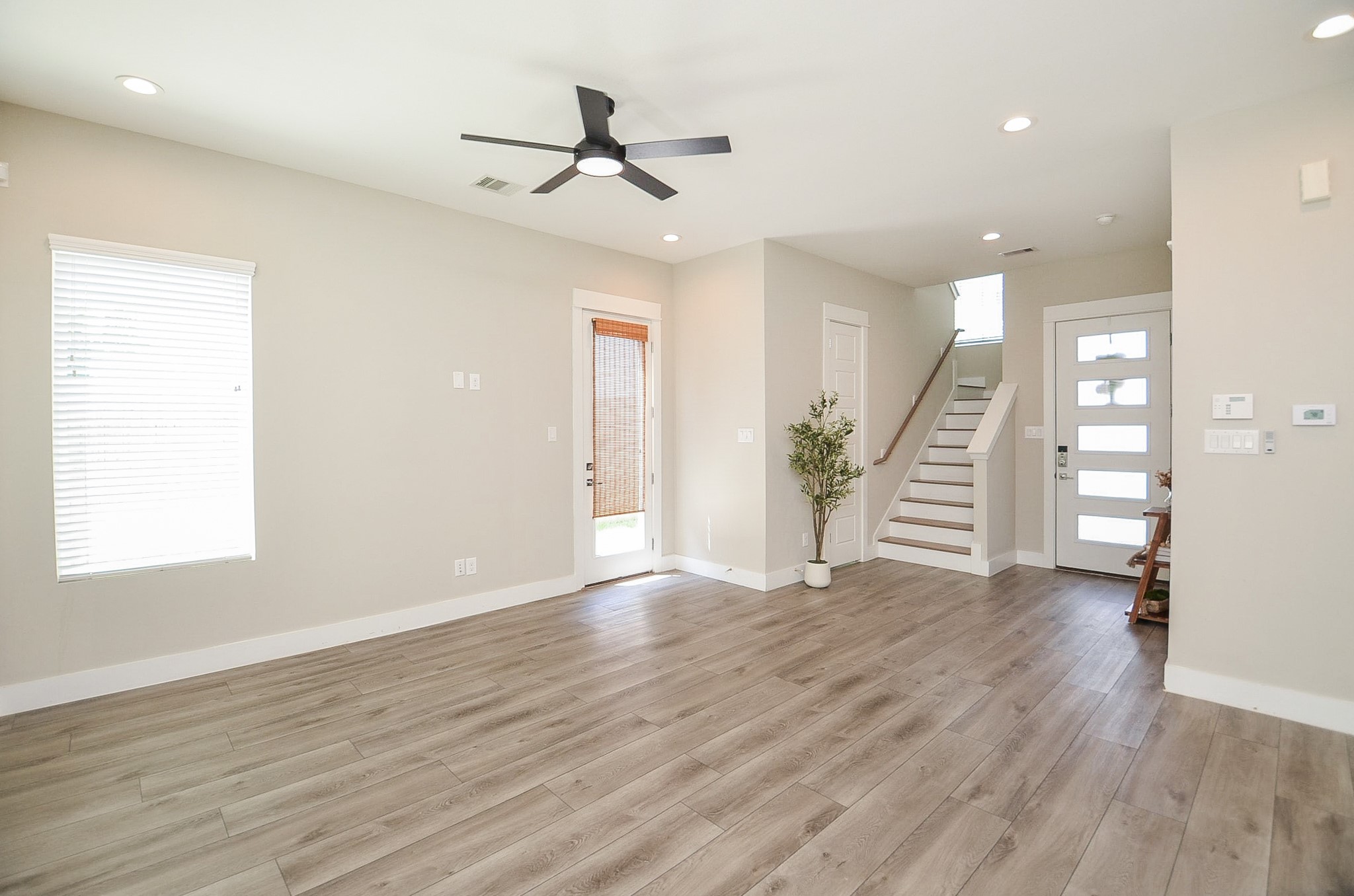 1223 West Tidwell Road Houston, TX 77091 - Photo 9 of 30 Warm with an appearance of distressed wood flooring slows seamlessly throughout complemented with modern finishes.