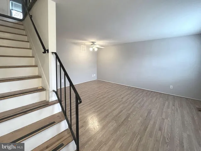 wooden floor in an empty room with stairs