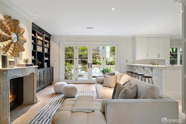 a living room with furniture a fireplace and a book shelf