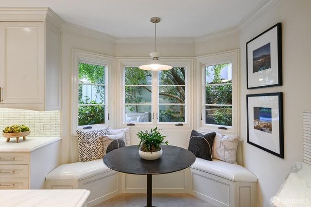 a view of a patio with couches table and chairs and potted plants