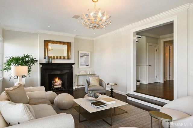 a living room with furniture a table and a large window