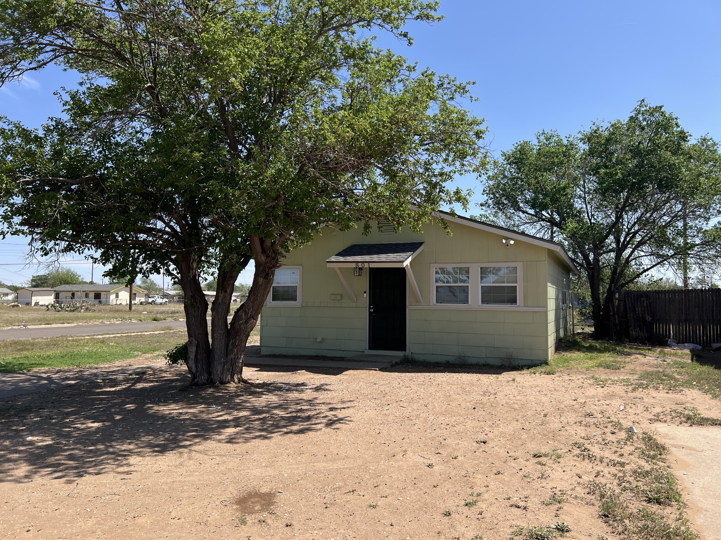 801 Vanda Avenue Lubbock, TX 79403 - Photo 1 of 13 a house with a tree in the background