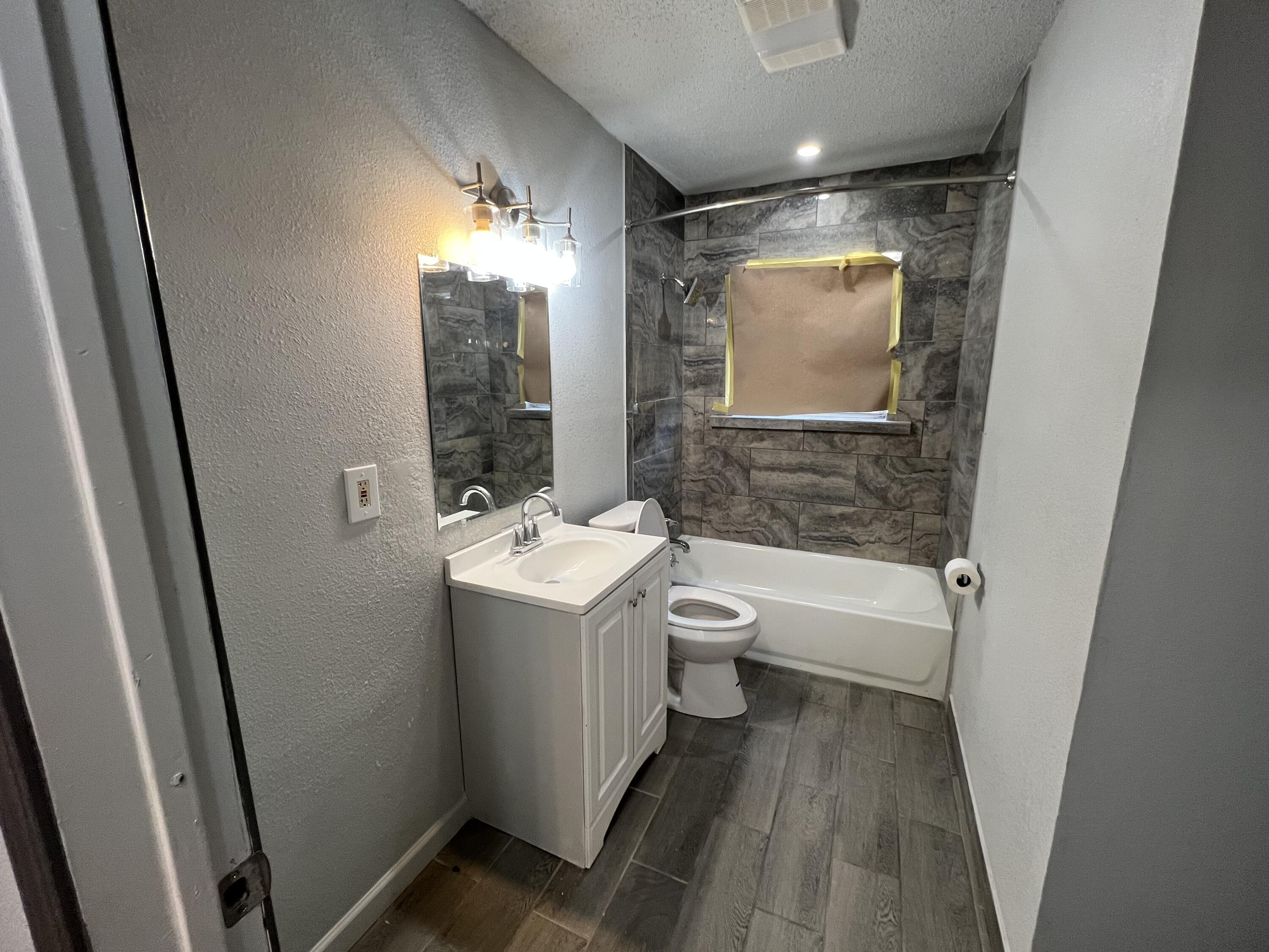 801 Vanda Avenue Lubbock, TX 79403 - Photo 10 of 13 a bathroom with a sink toilet and shower