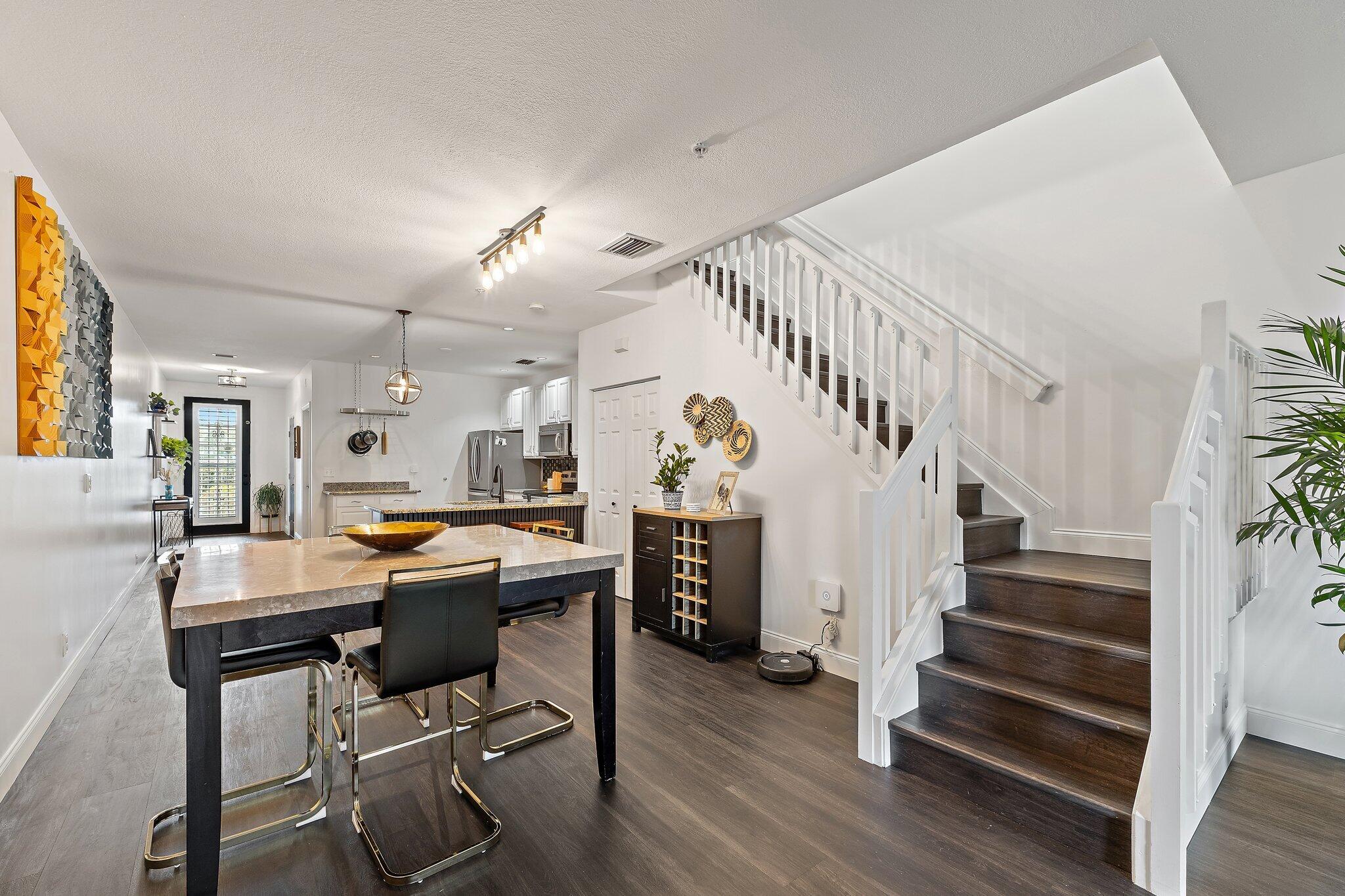 1101 Beach Road, Unit C Palm Beach Shores, FL 33404 - Photo 13 of 44 a view of a dining room with furniture and wooden floor