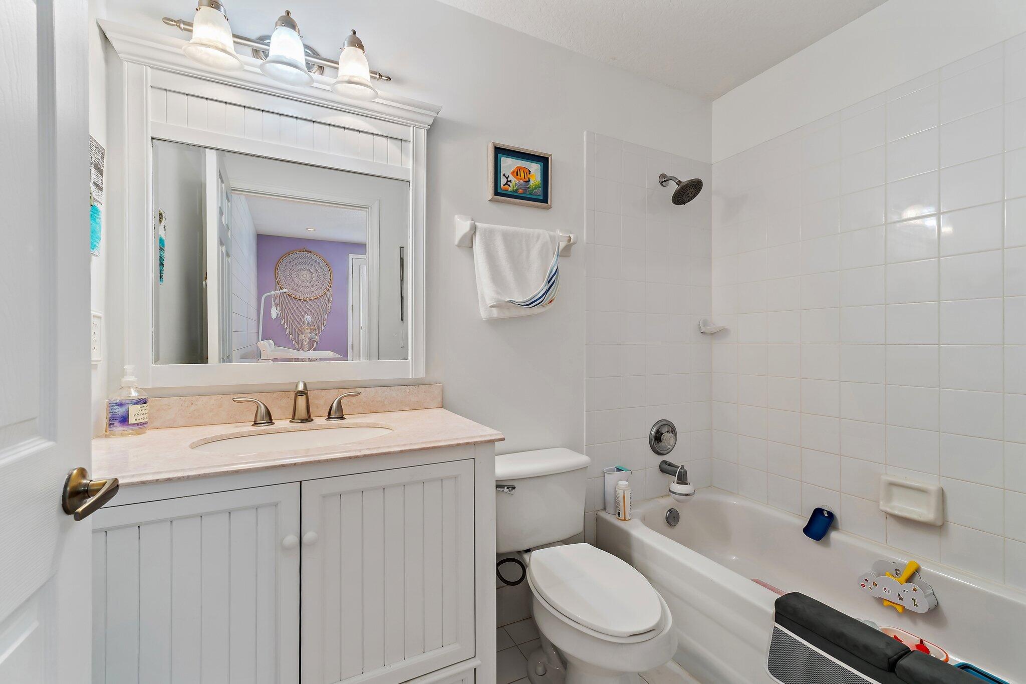 1101 Beach Road, Unit C Palm Beach Shores, FL 33404 - Photo 27 of 44 a bathroom with a sink a toilet and shower