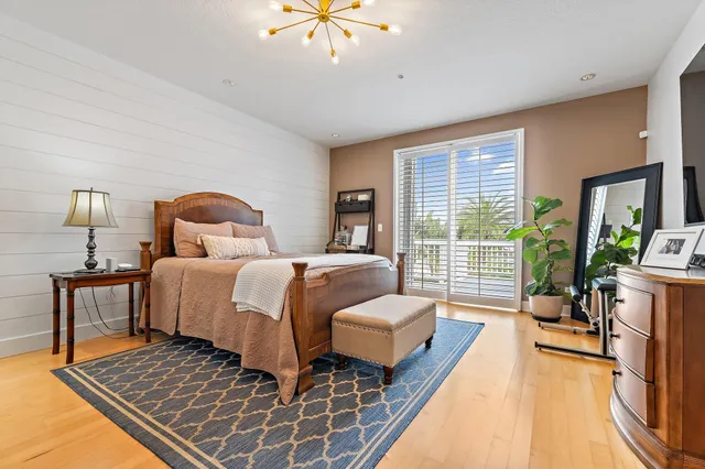 a bedroom with furniture and a large window