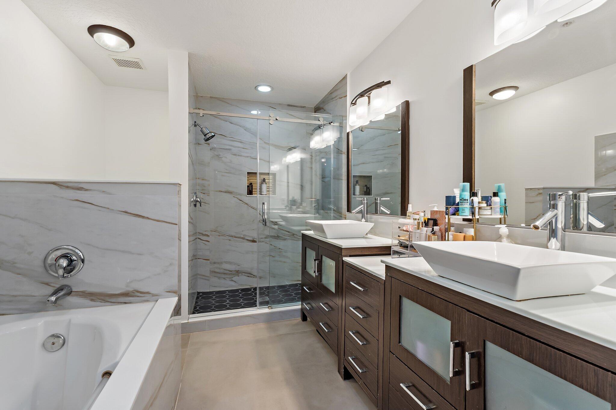 1101 Beach Road, Unit C Palm Beach Shores, FL 33404 - Photo 33 of 44 a bathroom with a sink double vanity granite tub shower and mirror