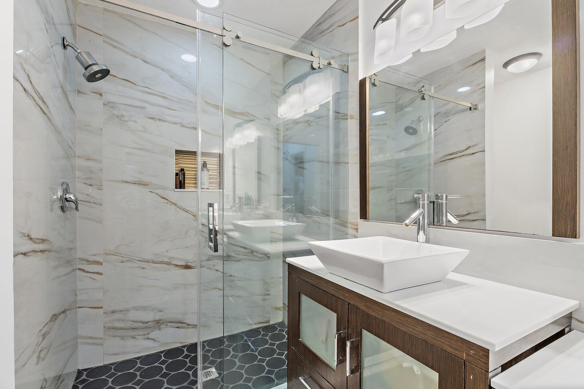 1101 Beach Road, Unit C Palm Beach Shores, FL 33404 - Photo 34 of 44 a bathroom with a sink shower and a mirror