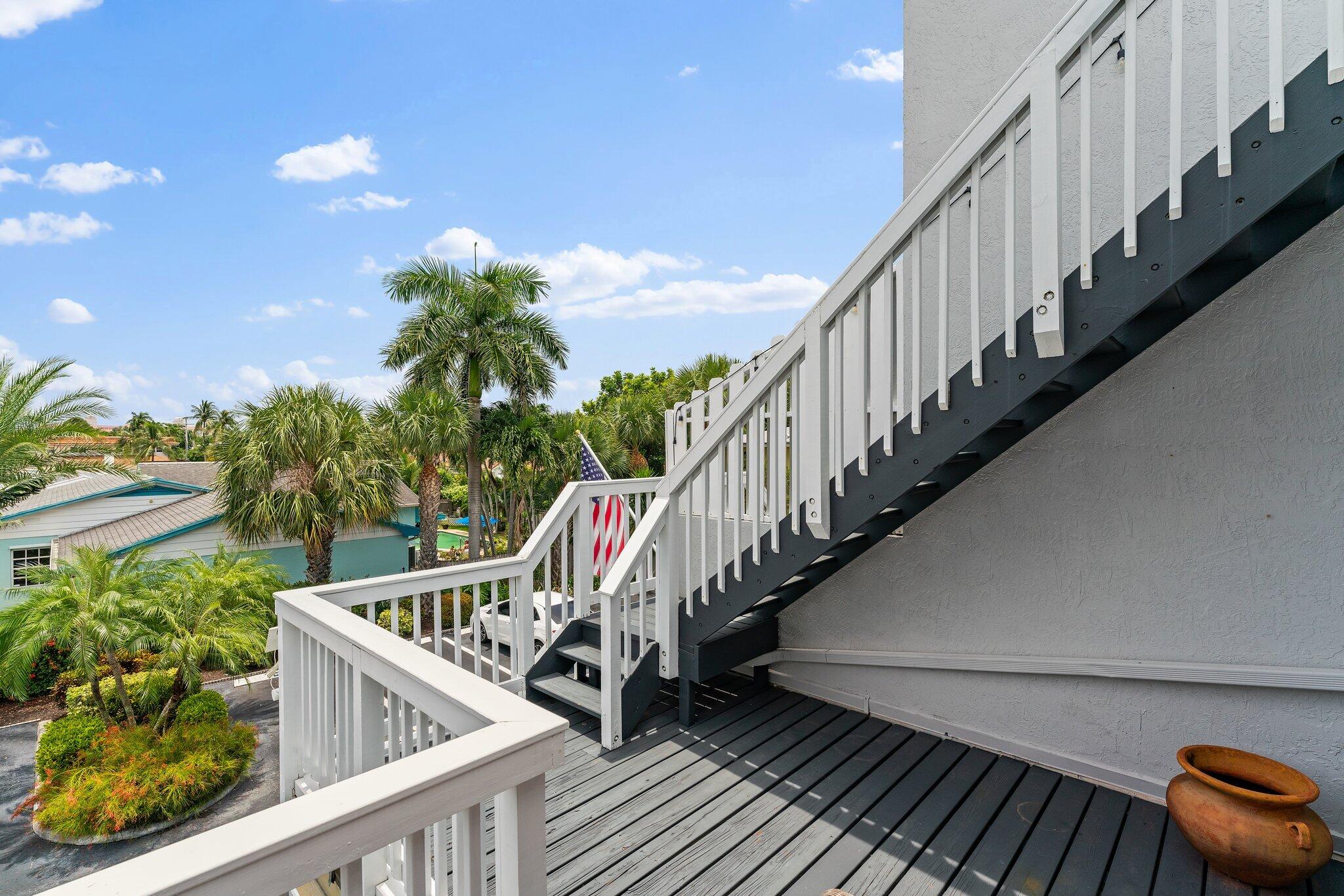 1101 Beach Road, Unit C Palm Beach Shores, FL 33404 - Photo 36 of 44 a balcony with wooden floor and stairs