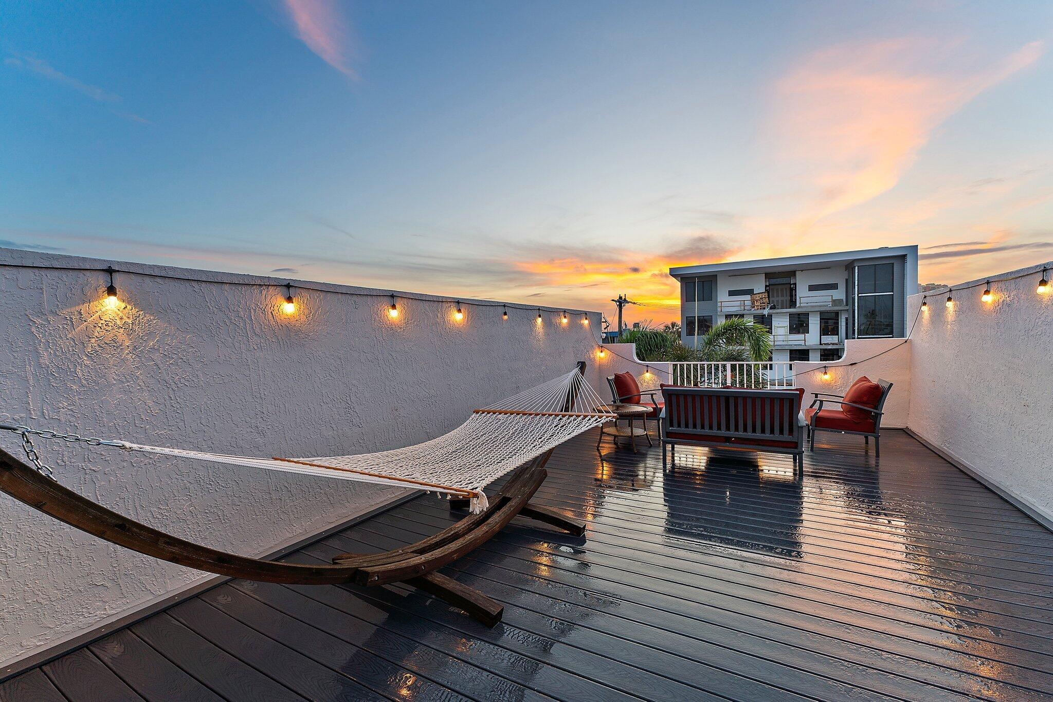 1101 Beach Road, Unit C Palm Beach Shores, FL 33404 - Photo 40 of 44 a roof deck with table and chairs