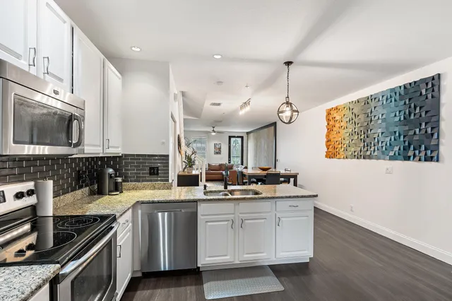 a kitchen with a sink stove and microwave