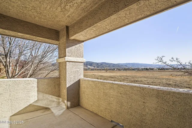 a view of a white house with a clock and a yard