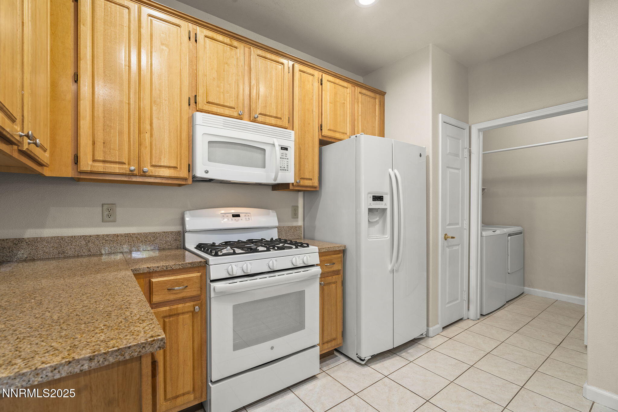 900 South Meadows Parkway, Unit 4321 Reno, NV 89521 - Photo 14 of 40 a kitchen with a stove a sink and a refrigerator