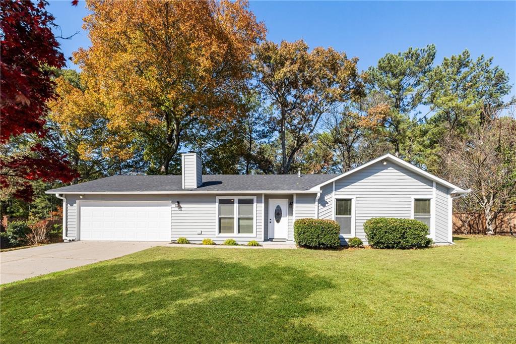 130 Forrest View Terrace Johns Creek, GA 30022 - Photo 1 of 34 a front view of a house with a yard and garage
